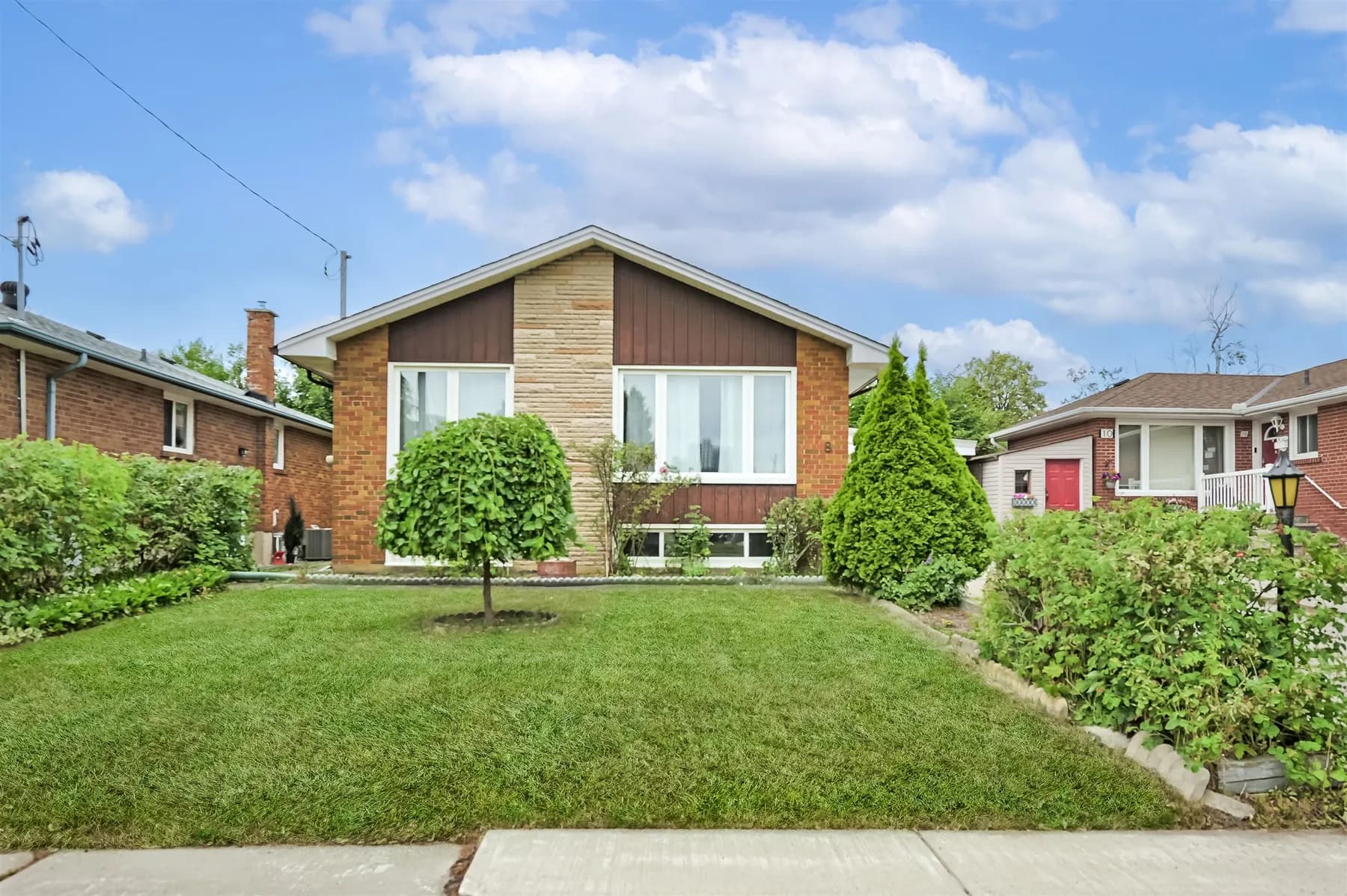 Front of 8 Murmouth Road, a brick bungalow with a landscaped front lawn